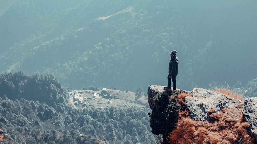 person climbing mountain