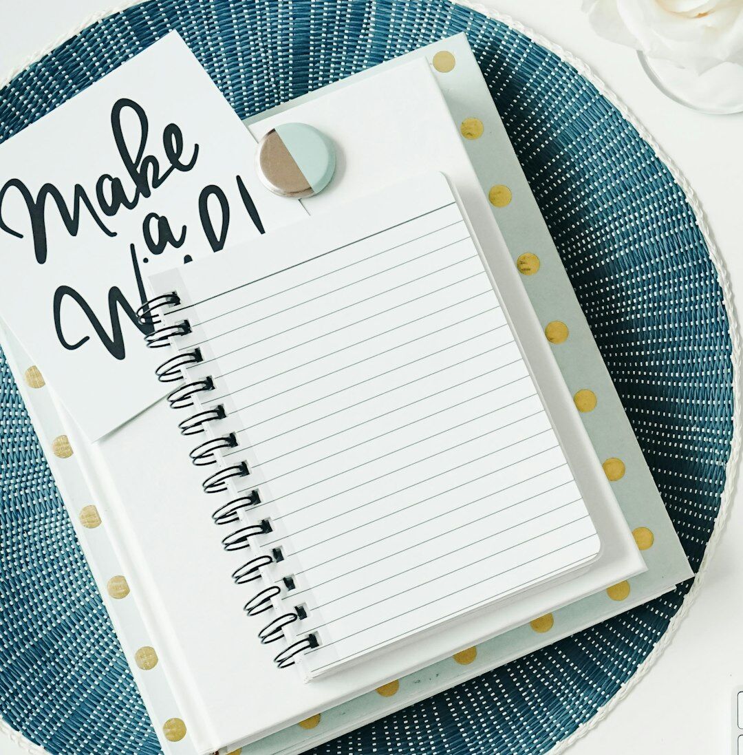 Man in a one-on-one mentoring conversation with a notebook on the table