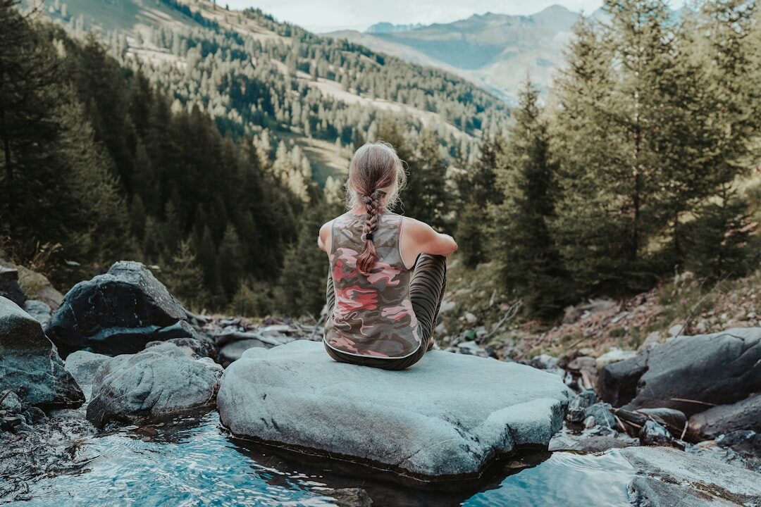 person meditating in nature